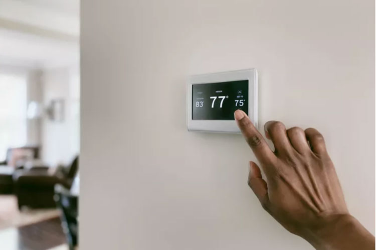 Person adjusting thermostat